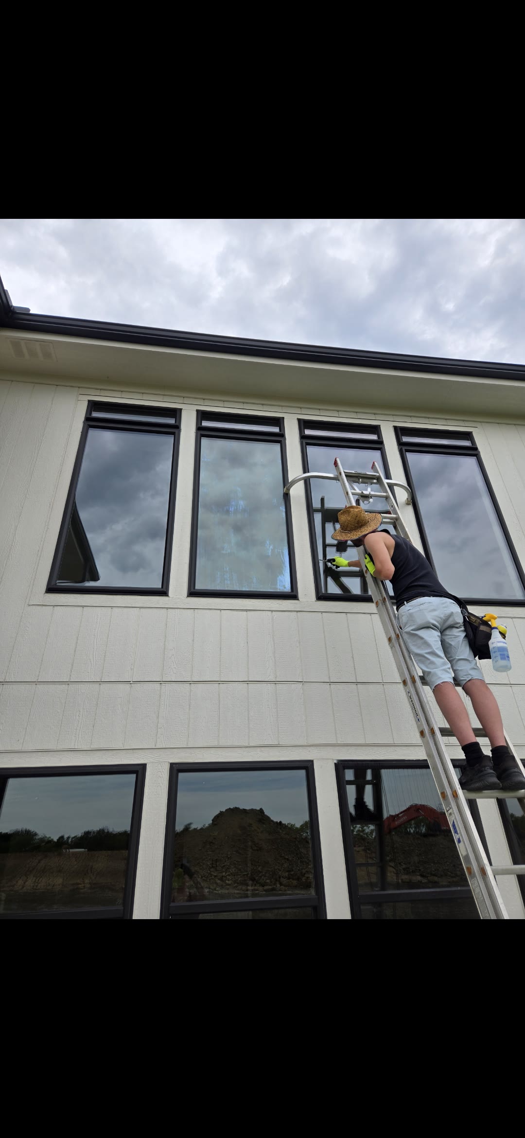 Professional window washing on a residential building